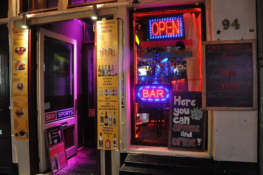 	
Coffeeshops are establishments in the Netherlands where the sale of cannabis for personal consumption by the public is tolerated by the local authorities (in Dutch called gedoogbeleid).
Under the drug policy of the Netherlands, the sale of cannabis products in small quantities is allowed by 'licensed' coffee shops. The majority of these "coffeeshops" (in Dutch written as one word) also serve drinks and food. Coffeeshops are not allowed to serve alcohol (although in the past some coffeeshops in central Amsterdam have transgressed this law without reproach) or other drugs, and risk closure if they are found to be selling soft drugs to minors, hard drugs or selling alcohol without a license. The idea of coffeeshops was introduced in the 1970s for the explicit purpose of keeping hard and soft drugs separated.
In the Netherlands, 105 of the 443 municipalities have at least one coffeeshop. Many at the borders sell mostly to foreigners (mostly from Belgium, Germany and France), who can also buy marijuana in their own countries, but prefer the legality and higher product quality of Dutch coffeeshops. In May 2011 the Dutch confirmed plans to ban foreigners from patronizing coffee shops, and to roll out the policy in the southern provinces of Limburg, Noord Brabant and Zeeland by the end of 2011 and the rest of the country in 2012. Coffeeshops become members-only clubs, while only adults living in the Netherlands can become a member.
Dutch coffee houses not serving marijuana are called koffiehuis (literally "coffee house"), while a café is the equivalent of a bar. [Wikipedia.org]