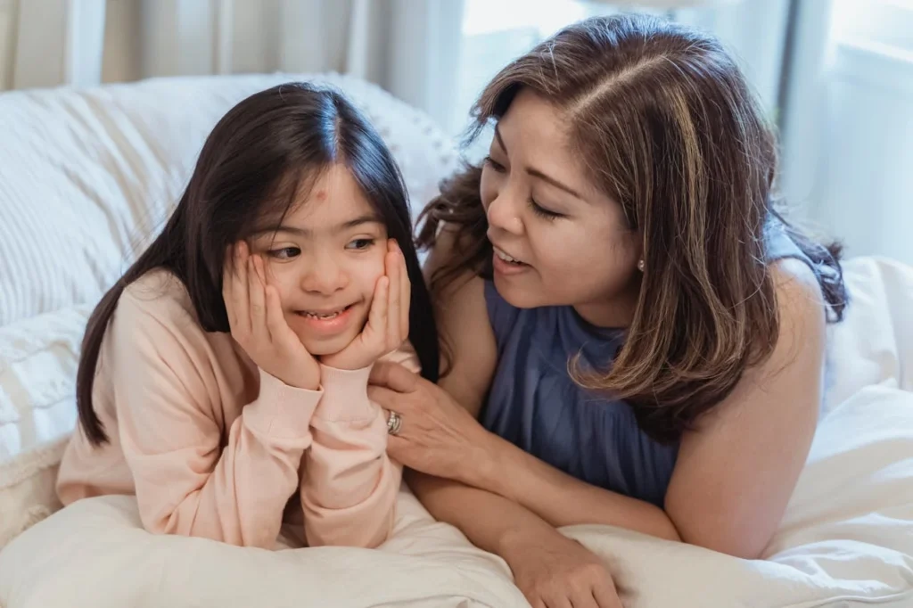 World Autism Awareness Day (April 2): Raising Awareness, Understanding, and Inclusion. A Woman and a Young Girl Sitting on the Bed